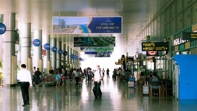 people walking inside building with blue and white signage